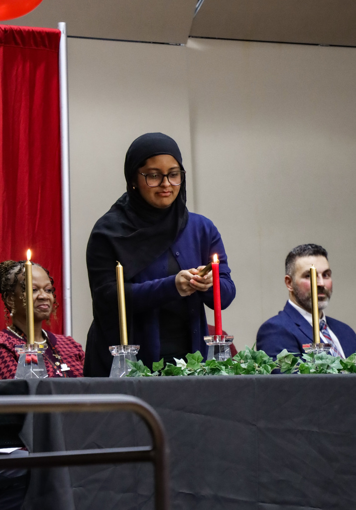NHS member lighting candle