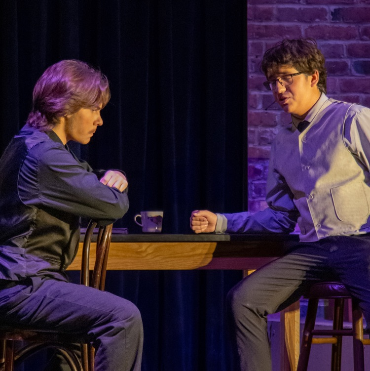 Two men sitting discussing business plans