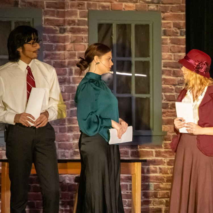 Three people standing and having a conversation