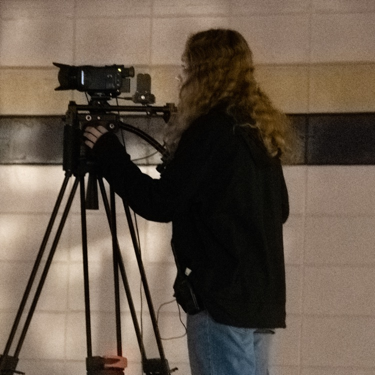 A woman operating a camera 