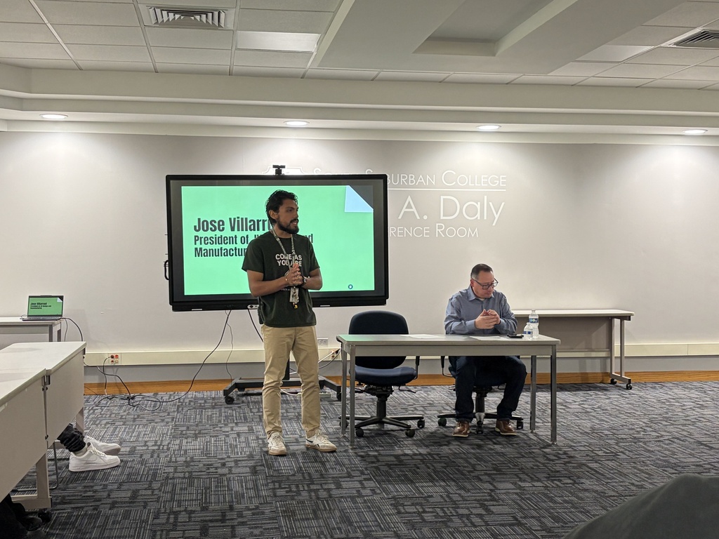 A Delta Academy staff member speaks to students as guest speaker Jose Villarruel sits nearby during a Hispanic Heritage Month program at South Suburban College.