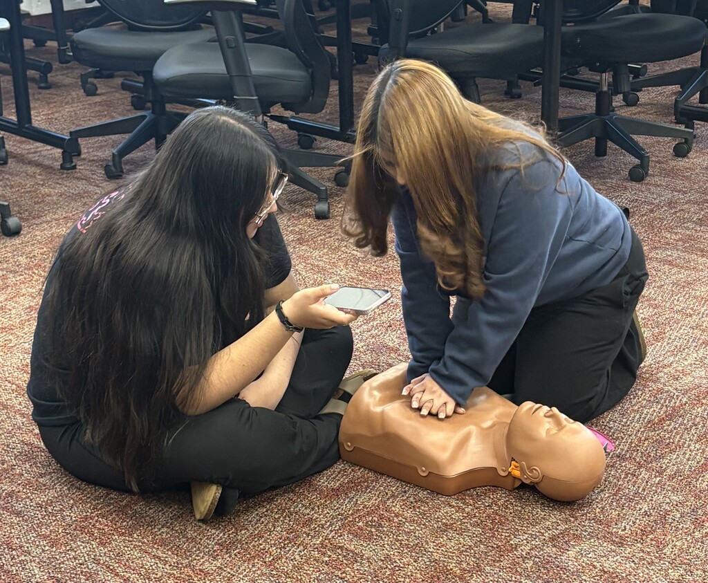 Students in Mrs. Flannigan’s Child Care 2 class practice CPR and First Aid skills during certification training.