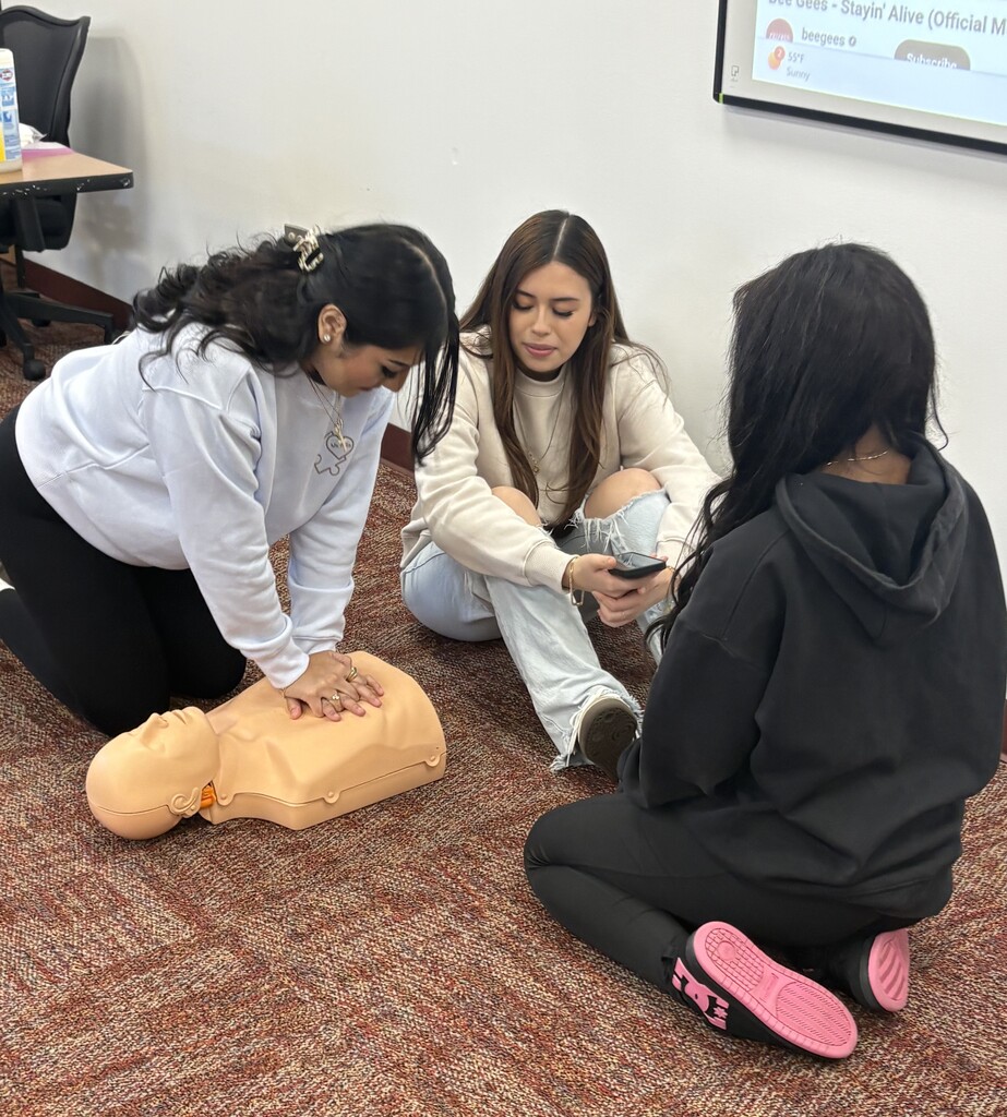 Students in Mrs. Flannigan’s Child Care 2 class practice CPR and First Aid skills during certification training.