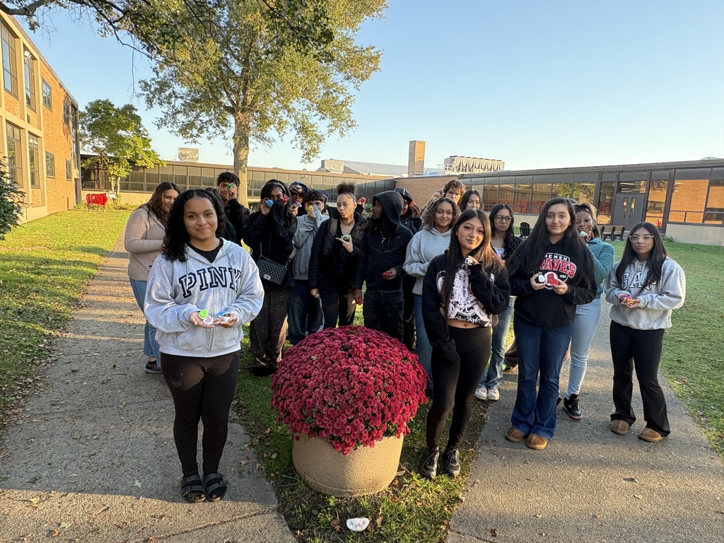Students in Mrs. Mack’s Introduction to Human Development class paint rocks with positive messages to place in the school courtyard, combining a creative stress-management activity with encouragement for others.