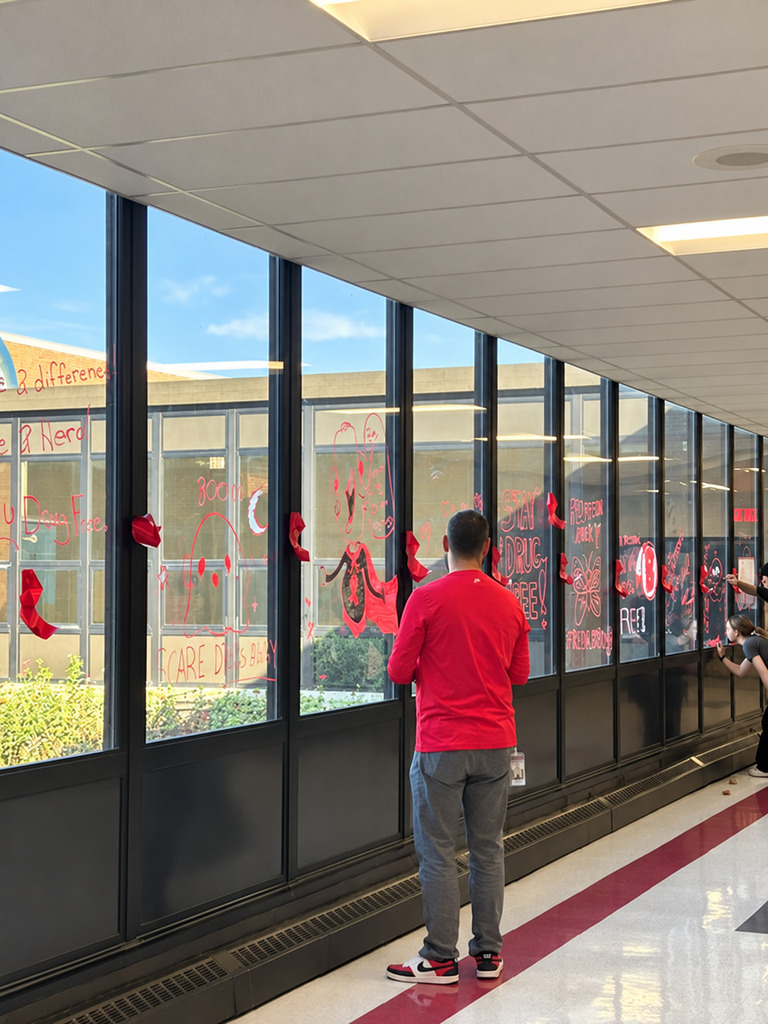 Snowball team members and student volunteers decorate school hallways and windows with positive, encouraging messages for Red Ribbon Week.