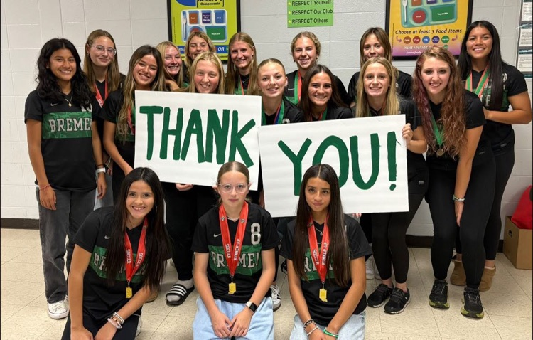 soccer team with thank you signs 