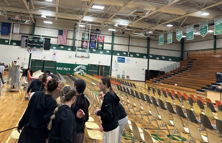 athletes setting out chairs 