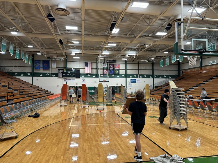 people helping put up chairs 