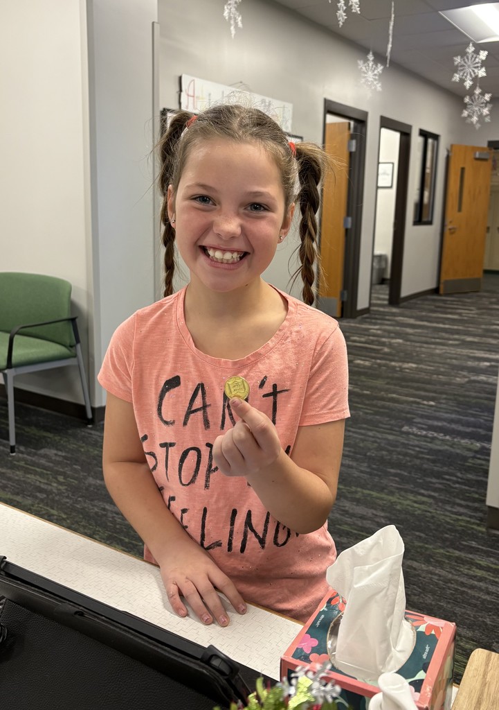 Girl in a pink shirt with a token