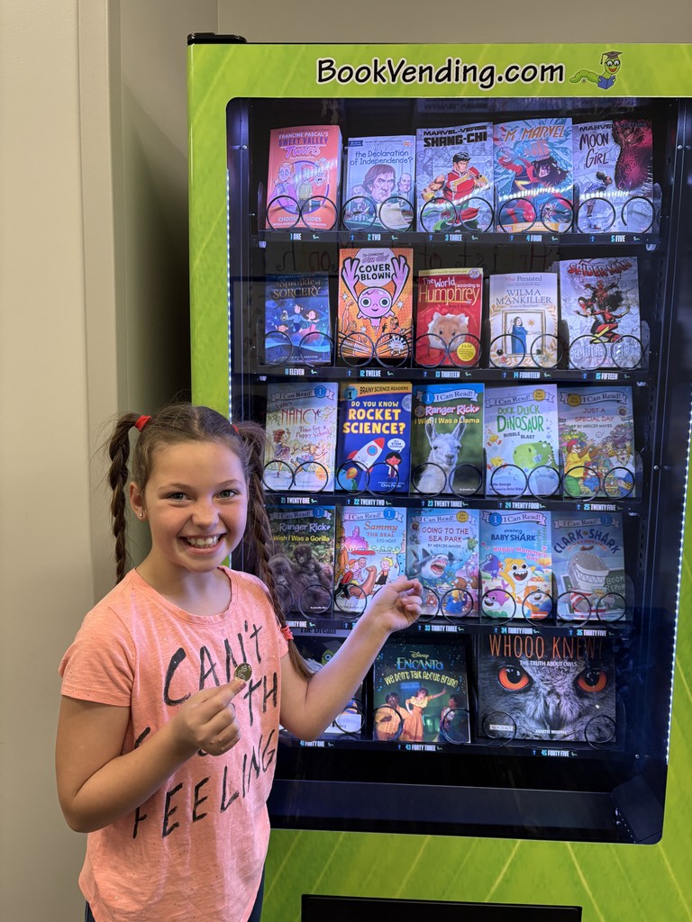 A girl picking out the book she wants