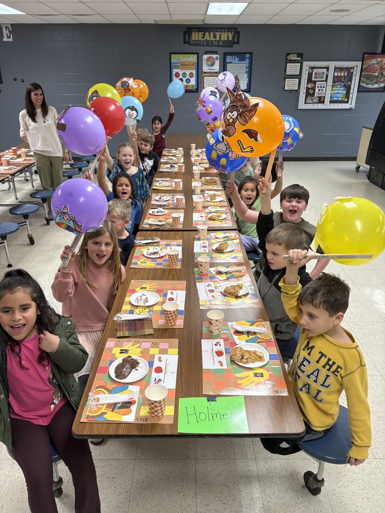 1st grade class with their balloons in the cafeteria