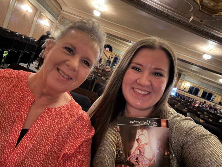 mom and daughter holding playbill