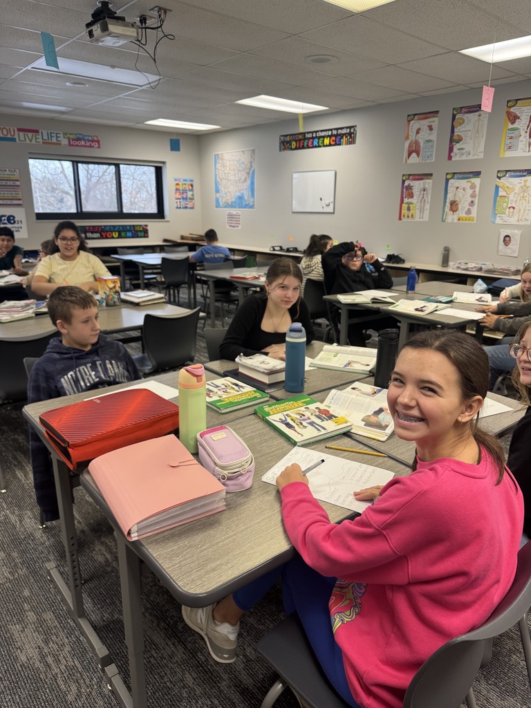 Girl in pink sweatshirt smiling.