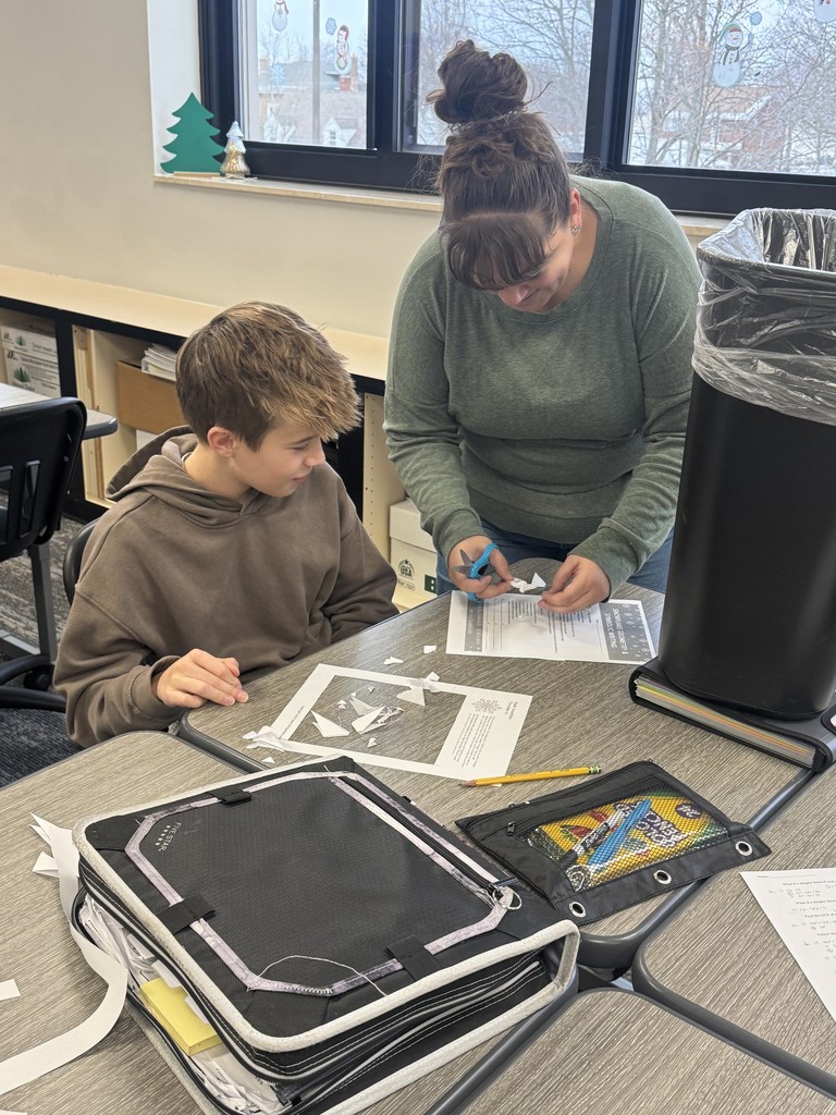 Teacher helping student.