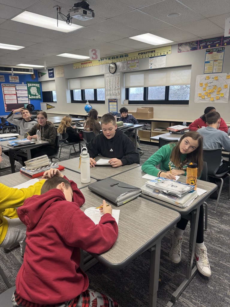 Students sitting around a desk.