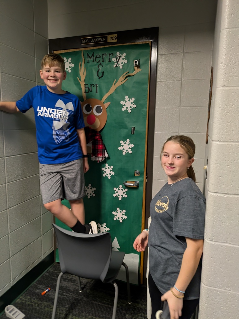2 Students standing outside a decorated door