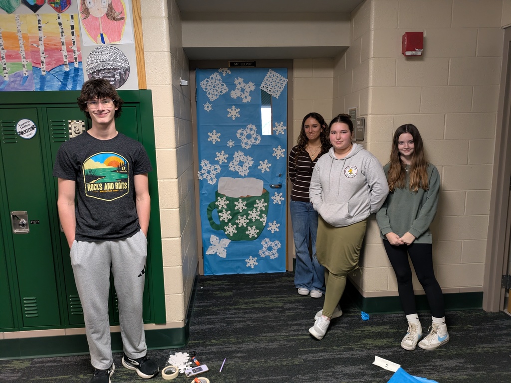 Students in front of a decorative door with snow flakes on it