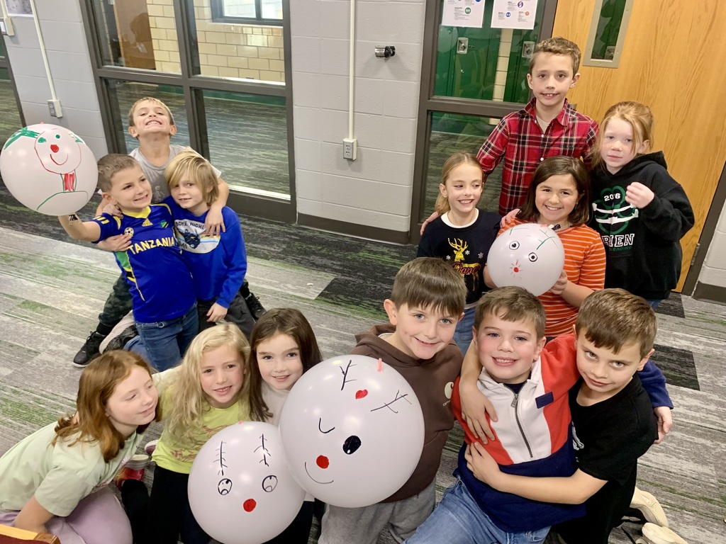 A group of students with ballons that look like reindeers.