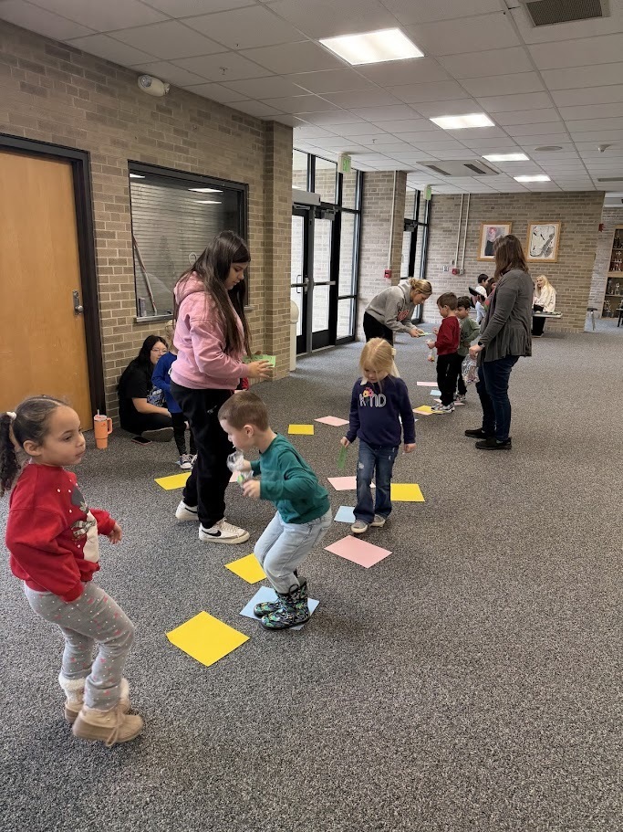 kids with papers on the floor