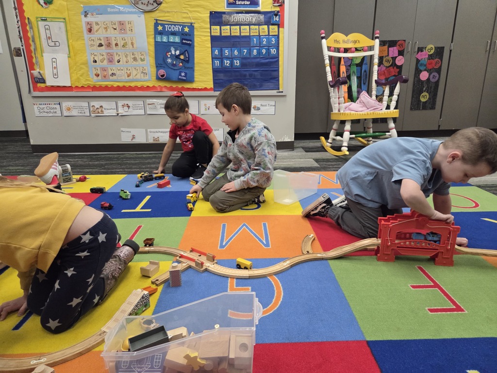 3 students making a train track