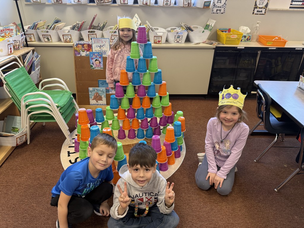 Four Students stacking a 100 colorful cups