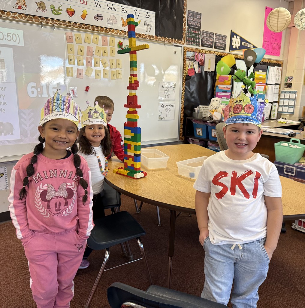 Three students stacking 100 blocks