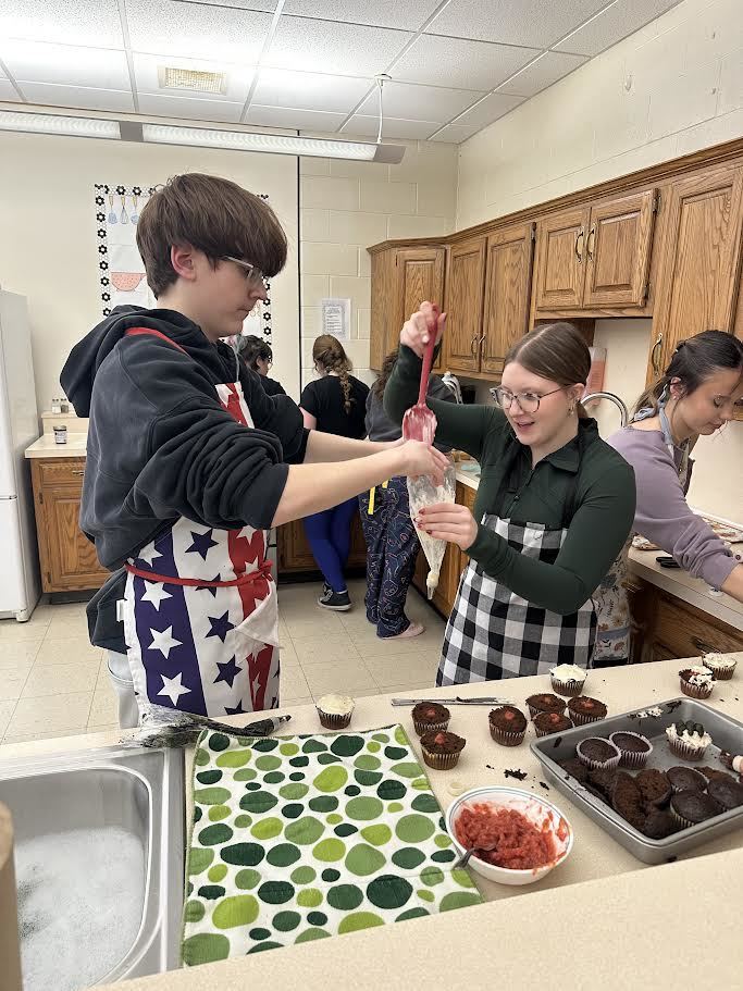 students filling cupcakes