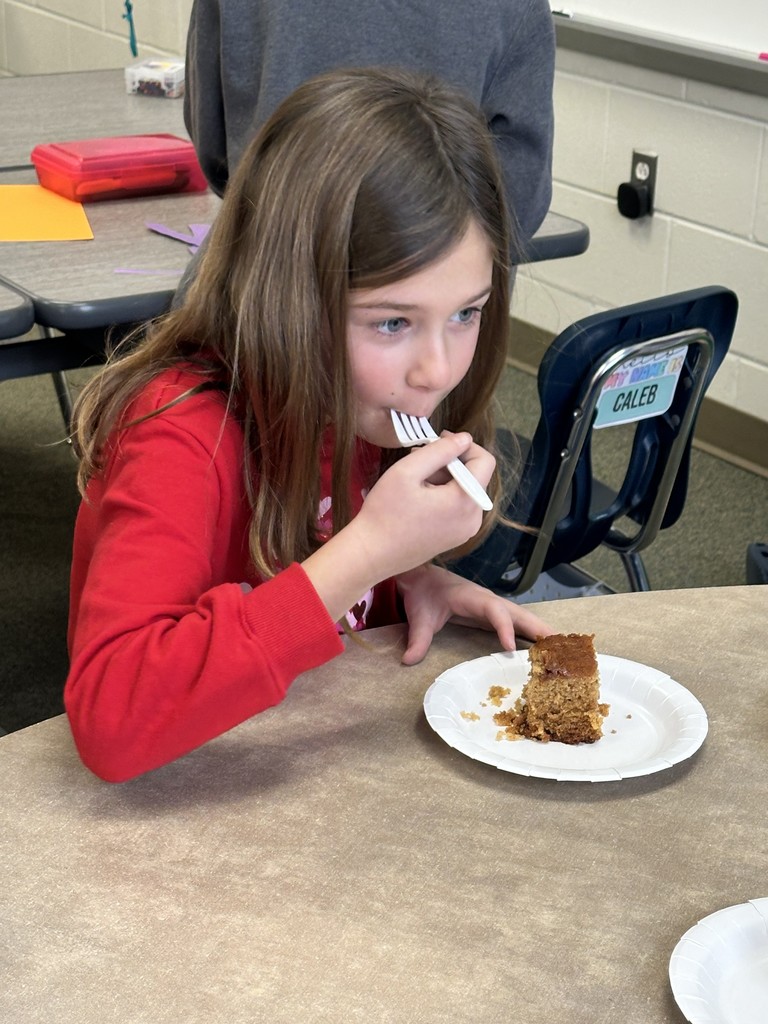 a girl eating a honey cake