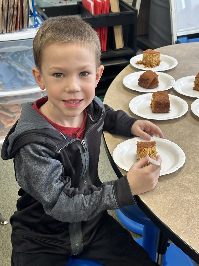 a boy eating a piece of honey cake