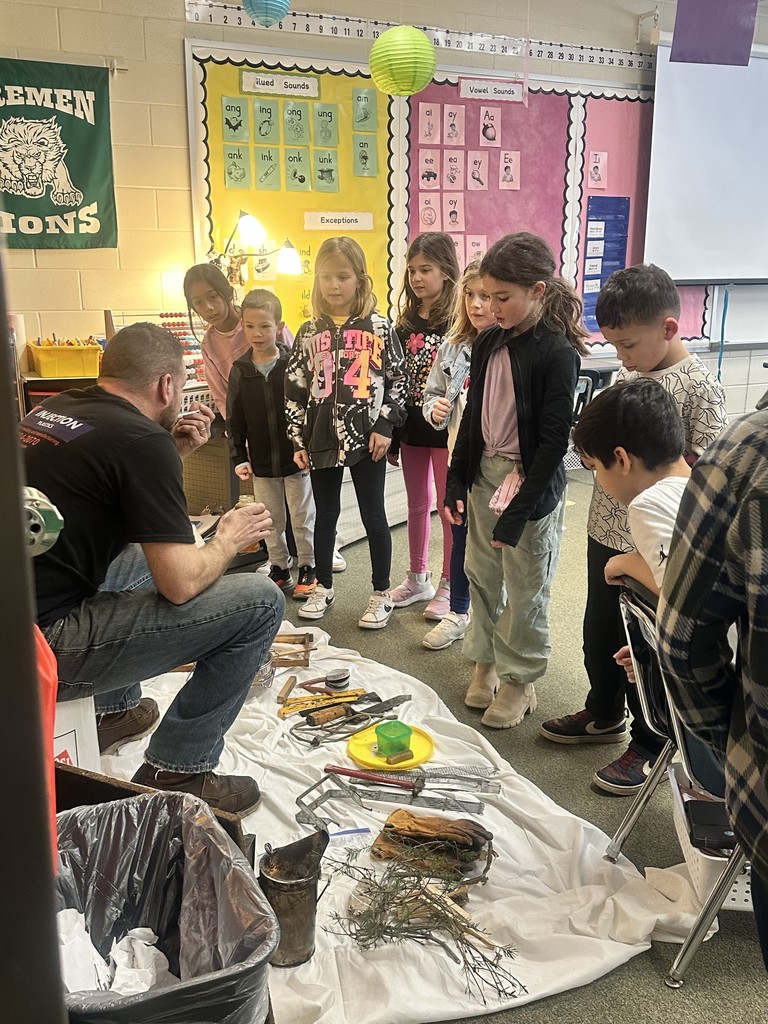 students looking at the beekeepers tools