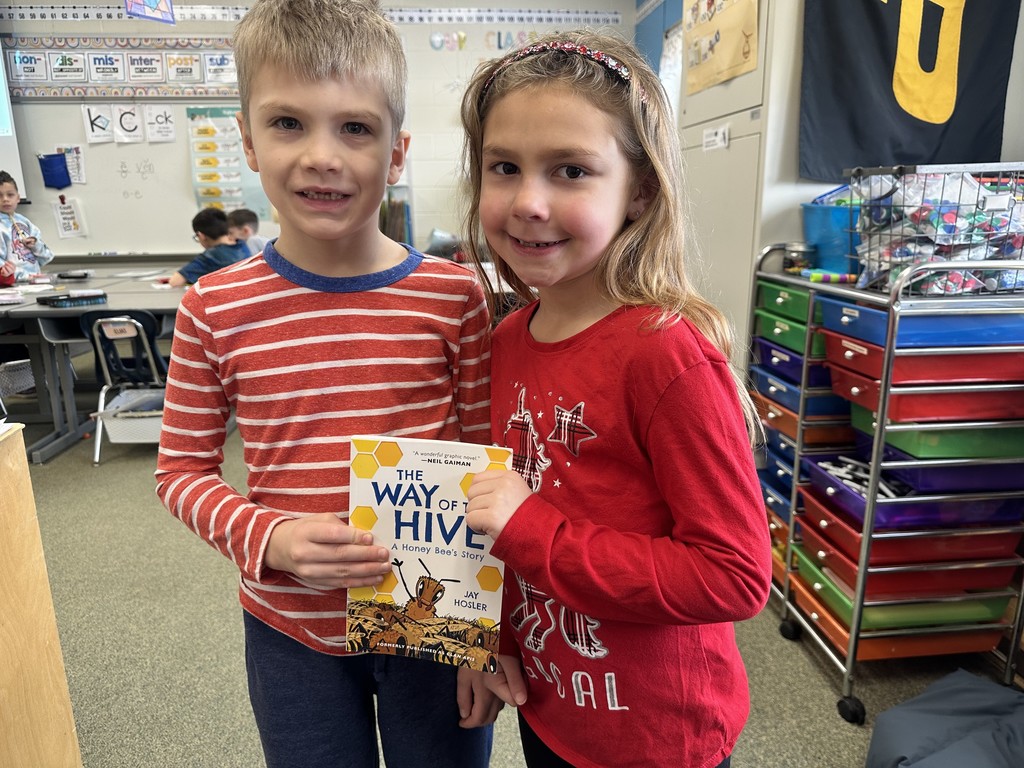 2 students showing the book they have been reading