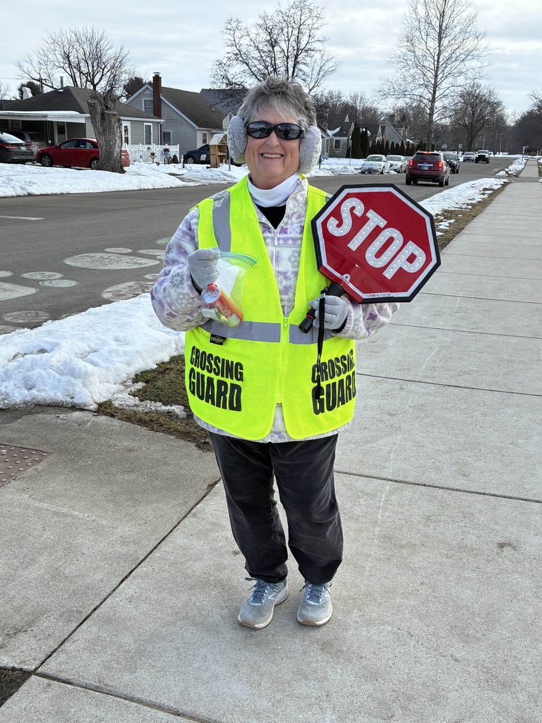 Crossing guard with  her sign 
