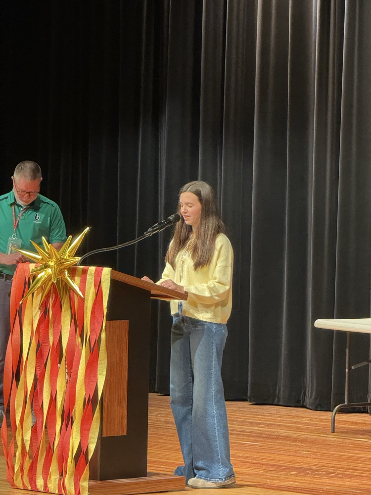 Rosalie gives a speech on the podium