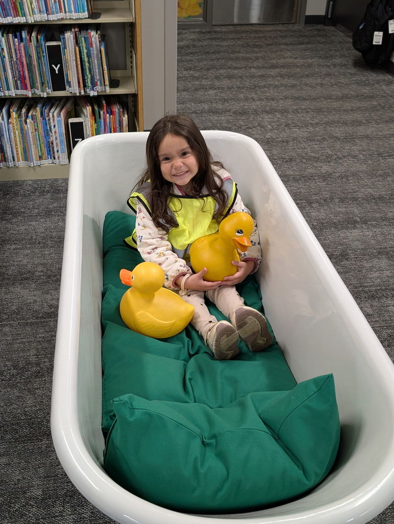 A student in a book bath tub