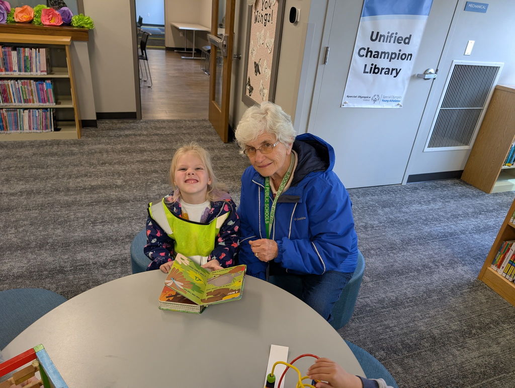 A student and aid reading a book