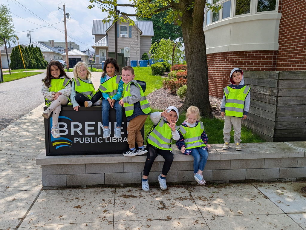 Students by the library sign