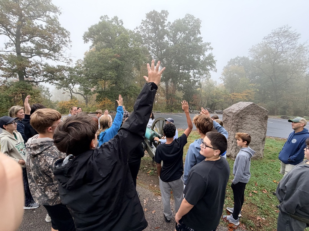 Students raising their hands to answer a question.