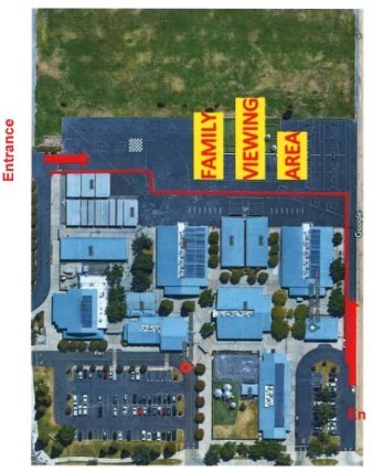 Family viewing area on Pioneer blacktop for Halloween Parade.