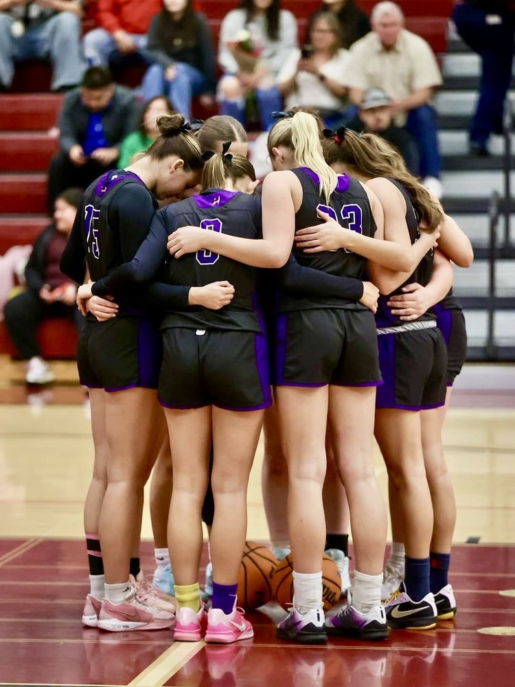 Girls Basketball team huddling