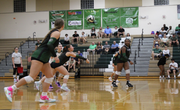Above The Net: Marley Sliwinski, a senior at Melbourne High School and a defensive specialist on her volleyball team, plays an essential role in helping her team succeed. Sliwinski has played volleyball for four years, and as a defensive specialist, she anticipates the ball's trajectory and executes quick, accurate digs to set up plays for her team. At this moment, Sliwinski plays on the court during a game, working with her teammates to secure the point. She remains focused and consistent in her performance, following her ritual of wearing a red hair tie for good luck. Sliwinski is determined to help lead the team through challenging moments with her leadership and skills. Sliwinski says, "Being on the high school volleyball team makes me a more rounded person." Sliwinski plays with the aim of contributing to her goal for the season win the district championship and celebrate the hard earned success with her teammates. Photo by Hunter Paige.