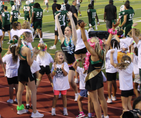 MIRACLE ENTHUSIASM: With the crowd roaring and the scoreboard lighting up, the Bulldogs score a thrilling touchdown. Miracle Dancer Lila Knight and Mini Miracles burst into celebration on the sidelines. It’s all happening at our home game against the University Titans, held on the first Friday of September—a night packed with school spirit and unforgettable moments. “I hope to make a positive impact and inspire the little girls.” Knight says. Photo by Issy Perez