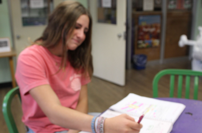 Caption: Focused on Geometry: 9th grader Claire Miodek studies in class as she reviews her notes for an upcoming test. She practices problems to prepare for questions on justifying proofs. “I felt pretty confident because I studied,” Miodek says.