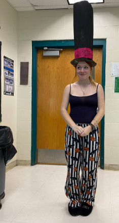 Lindy Roy poses for a photo with the hat she made in art class.”I had so much fun making my hat.” Photo by Braelyn Arenella-White.
