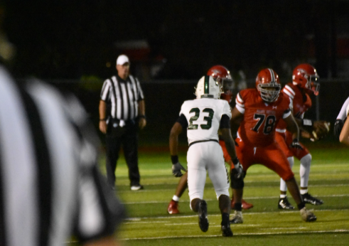On a cool Friday night under the bright stadium light, number 23 from the visiting team charges forward con defense. The crowd watches intensely from the stands.The quarterback prepares to throw while the offensive line blocks fiercely. Every player is locked in, determined to make the next big play. The tension builds, will the defense stop the drive or give up first down. He said, “Never give up on something you love.” Photo creds: Anabella Mulligan