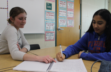 Caption:  Getting Help: Senior Maleina Olmscheid tutors sophomore Ayaana Gupta at Spanish tutoring, Tuesday, March 3rd after school. Olmscheid was the president of the Spanish Club and wanted to help as many students as possible. “We want to help prepare students to feel confident speaking and writing in Spanish, and to do their best on the final exams,” said Olmscheid. Photo by Kyra Chang