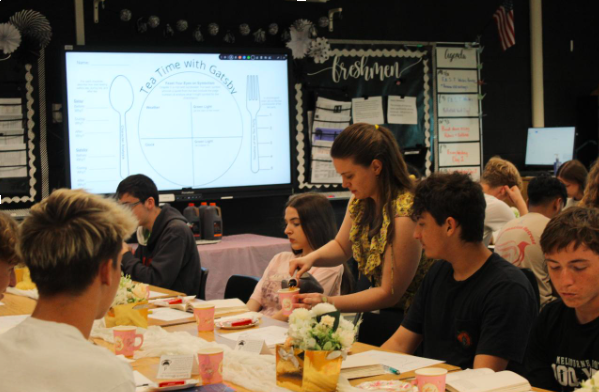 Mrs. Reynolds serves tea to 10th grades while the analyze symbolism in The Great Gatsby tea scene.