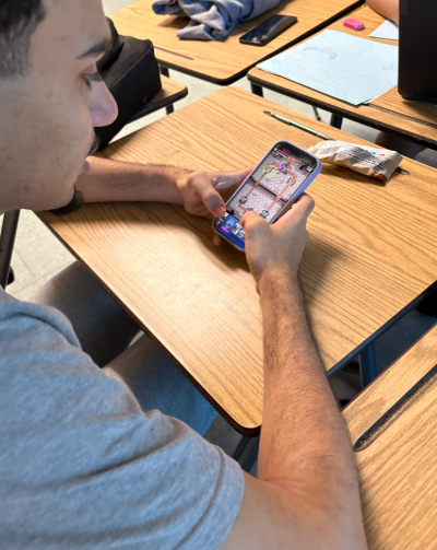 Clash, crush, repeat: Mustafa Alqurughuli, a junior at Melbourne High School, is dominating the Clash Royale Club with his strategic use of the Pekka Bridge Spam deck. Every week, he competes in intense club tournaments, where his quick decision-making and precise tactics consistently lead him to victory. His passion for the game not only drives his own success but also inspires other students to improve their skills. The club has become a hub for gamers, with Alqurughuli at the center, “Making new friends and playing my favorite game.” Alqurughuli helps elevate the level of competition among members. Photo by Hunter Paige