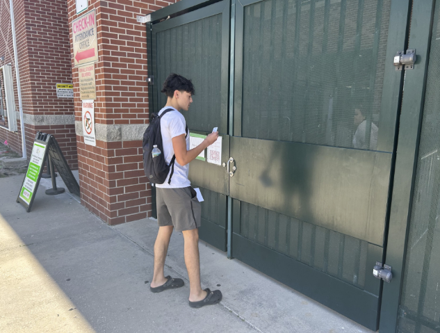 Simple or Complex: Senior Hugh Macdonald waits to be let into campus. Some students find entering the gate much simpler than using the Attendance Office when getting onto campus during lunch. “It doesn’t really bother me, and I like it more walking through the gates, but I don’t like the metal detectors. They haven’t given me much problems, I just feel they take up a lot of time. For me this year it wasn’t really an issue,” said Macdonald. Photo by Kyle McLaren