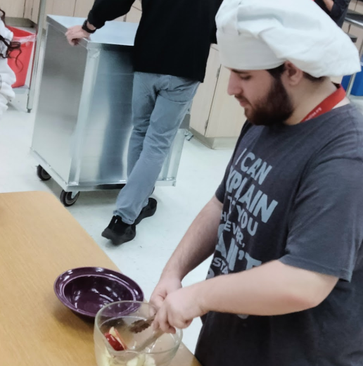 Perfectly Preparing the Goods: Dominic Ciano in Chef Haskin’s room during his second period class in building 10, preparing the previously chopped apples for dehydration. Chef Haskin’s has been at Mel High for six years, and worked in the Industrial scene for many years—this allowed him to make sure each student made prepared food for dehydration properly. Chef Haskins showed students how to cut fruits and vegetables correctly the day prior. “The reason I think its important is its a good skill to know when you live on your own; You don’t have to buy that many pre-made stuff, get your own ingredients, and cooking with those ingredients is typically cheaper.” said Ciano.  Photo by Tyler Ferreira Alves Hill.