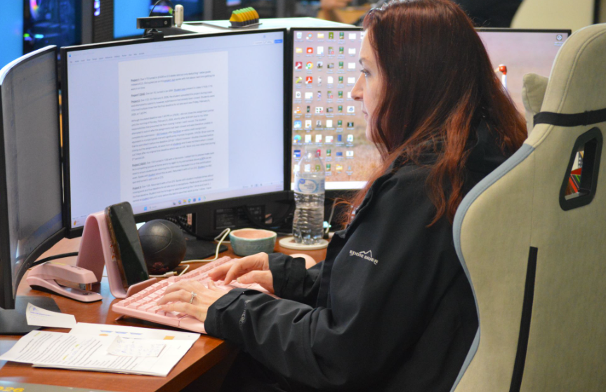 Diligently Doing Work for Digital Design: Ms. Liscum Maddox works hard on her computer during her period 3 class. Ms. Maddox had plenty of returning students from Digital Design 1 who entered Digital Design 2 and had begun teaching them programs such as Adobe Express and Adobe Acrobat Pro, alongside various fun projects unrelated to the programs. “Seeing students actually get their certifications is huge. It’s exciting for me—It’s exciting for the students, and it shows them that their hard work really does pay off. I love it.” said Ms. Maddox. Photo by Tyler Ferreira Alves Hill.